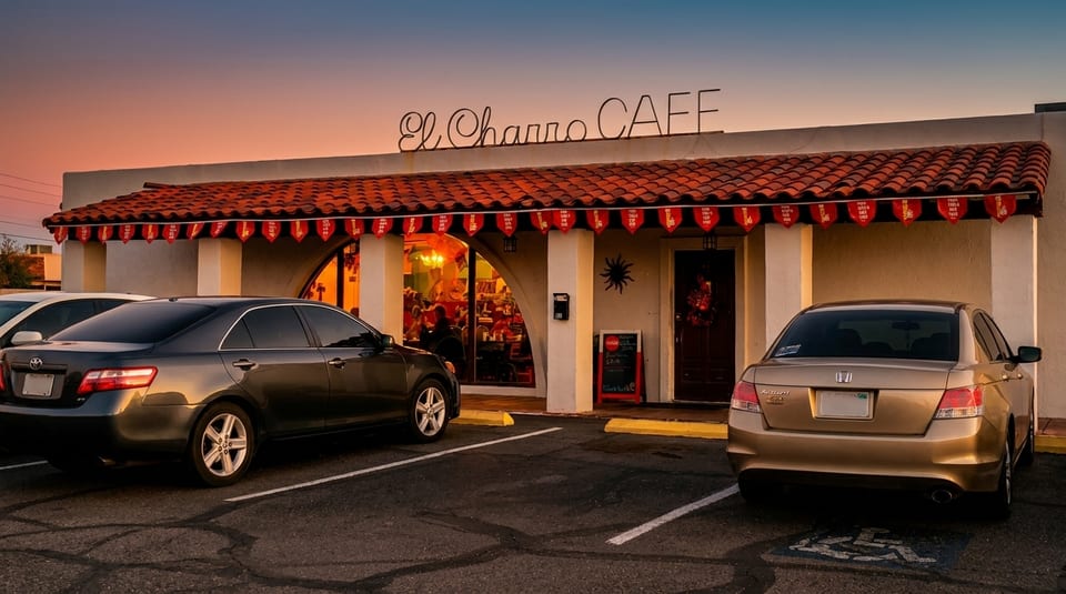 El Charro Cafe exterior at sunset, with two cars parked in front of the restaurant.