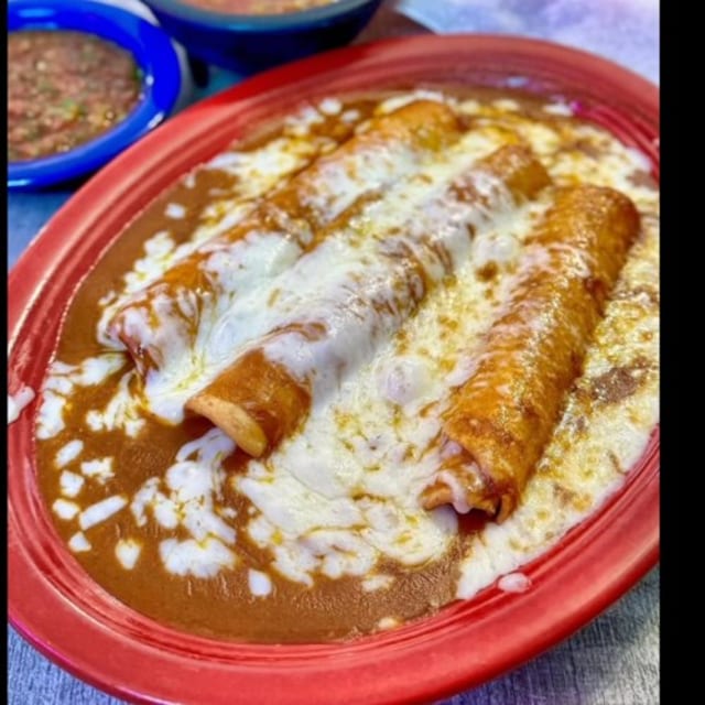 Three Sonoran Rolled Tacos Enchilada Style.